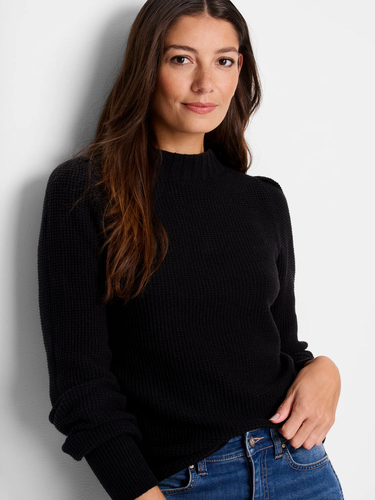 Black waffle-knit sweater. Mock neck, long sleeves, textured fabric.