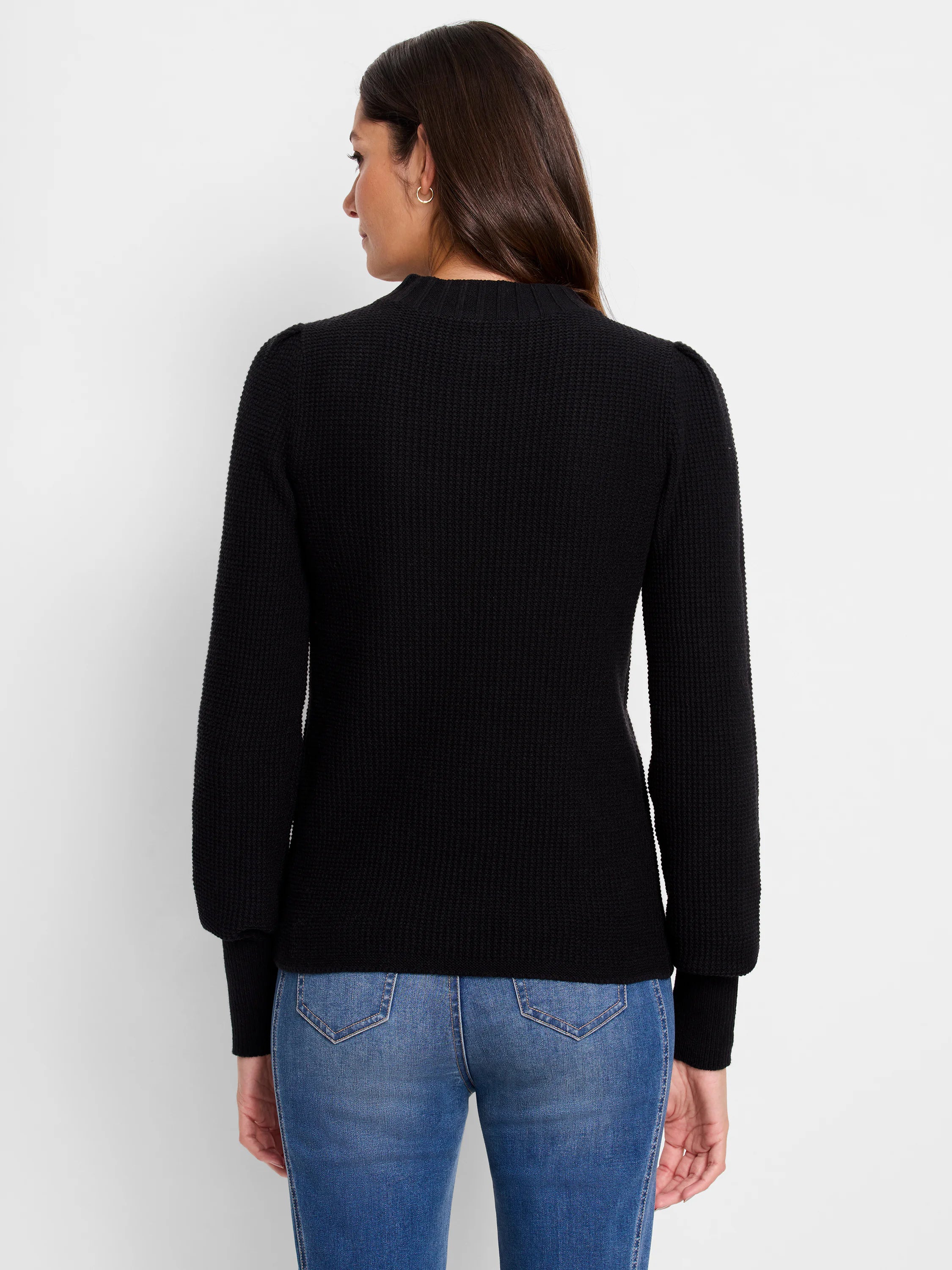 Black waffle-knit sweater, long sleeves with slight puff at shoulder, mock neck.