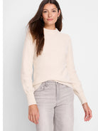 Off-white waffle-knit sweater with long sleeves and a mock neck.