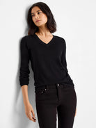 Black V-neck sweater tee; long sleeves.