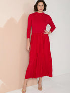 Red midi dress with pleated skirt and mock neck.  Three-quarter sleeves.