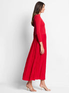 Red midi dress.  Fitted ribbed knit top, pleated skirt.  Model wears rose gold heels.