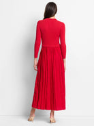 Red midi dress. Fitted ribbed knit bodice, pleated skirt.  Three-quarter sleeves.