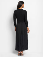 Black ribbed knit top and pleated maxi skirt.  Three-quarter sleeves.