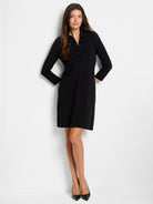 Black mini dress with ruffled collar, three-quarter sleeves, and a straight hemline.