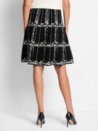 Black A-line knit skirt with an off-white etched plaid pattern.