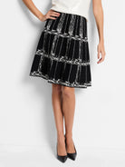 Black flared knit skirt with an off-white etched plaid pattern.