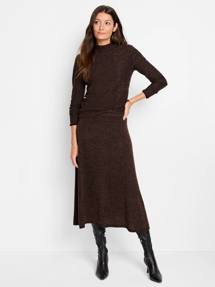 Dark brown midi pixel knit skirt with bronze flecks, worn by a model.