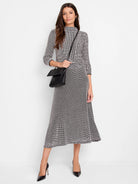 Black and white patterned midi-length A-line knit skirt.