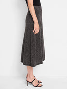 Black midi skirt with subtle gold flecks, knit texture, A-line shape.