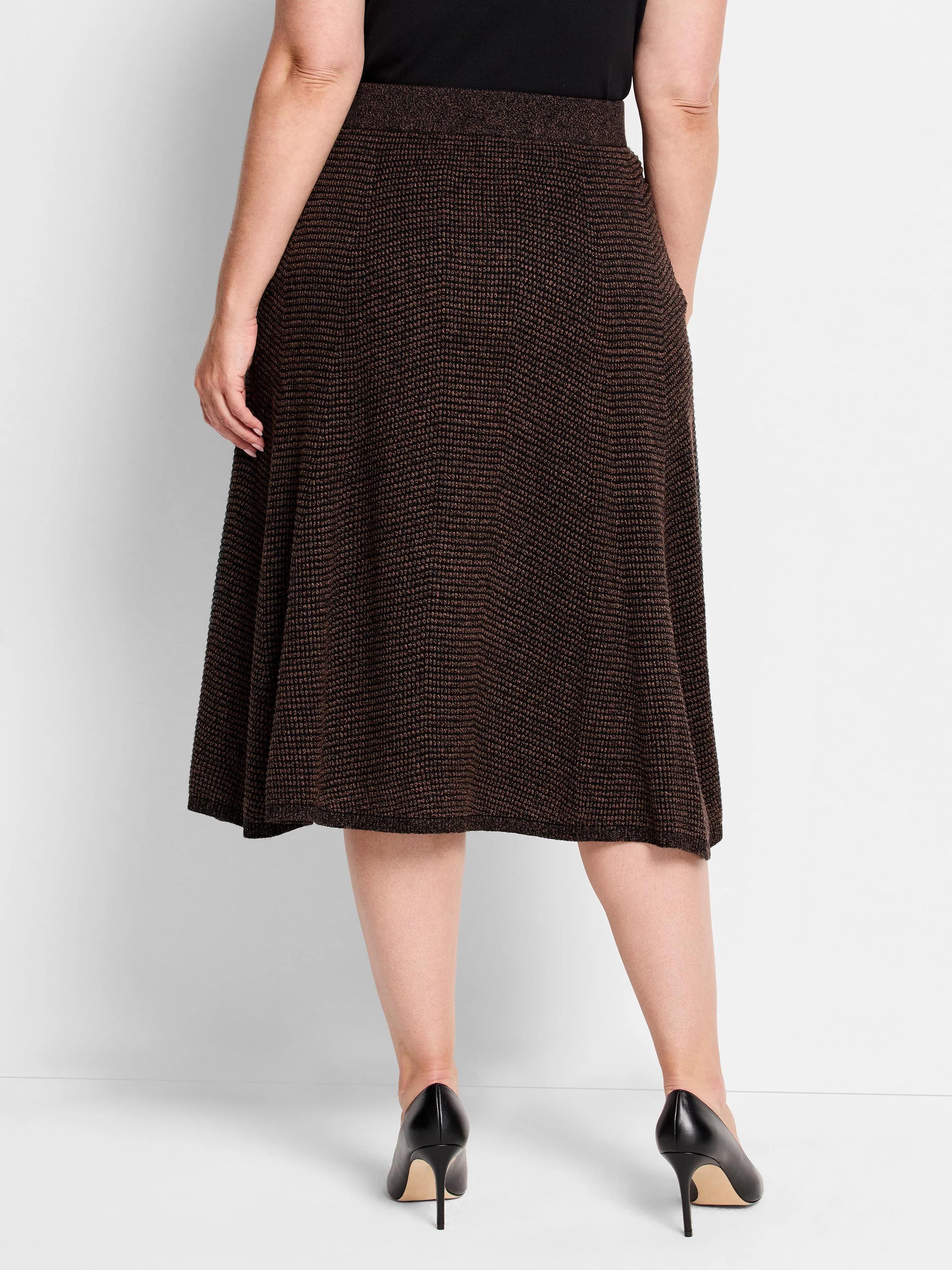 Dark brown pixel knit midi skirt with a subtle brown and black textured pattern. Flared A-line shape.