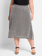 Black & white knit A-line skirt, knee-length. Features a pixel dot pattern and textured waistband/hem.