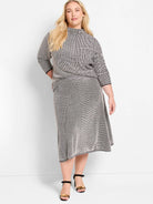 Black and white pixel knit midi skirt with a chevron pattern, A-line shape.