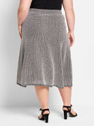 Black and white pixel knit A-line midi skirt, worn on a model from the back.