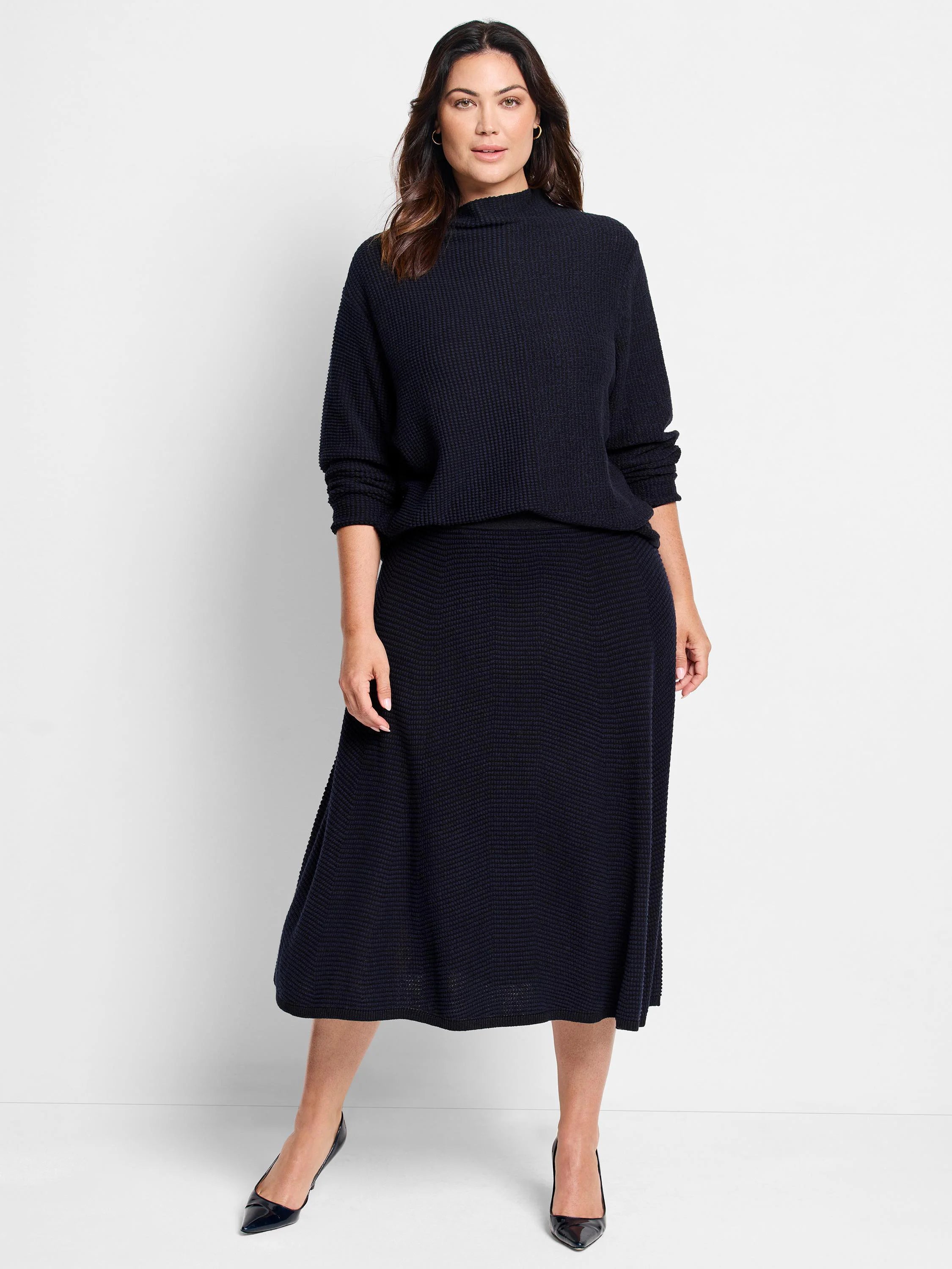 Dark navy A-line midi knit skirt with a subtle raised "pixel" texture.