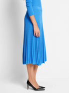 Bright blue midi-length ribbed sweater skirt with a smooth waistband and flared, wavy hem.