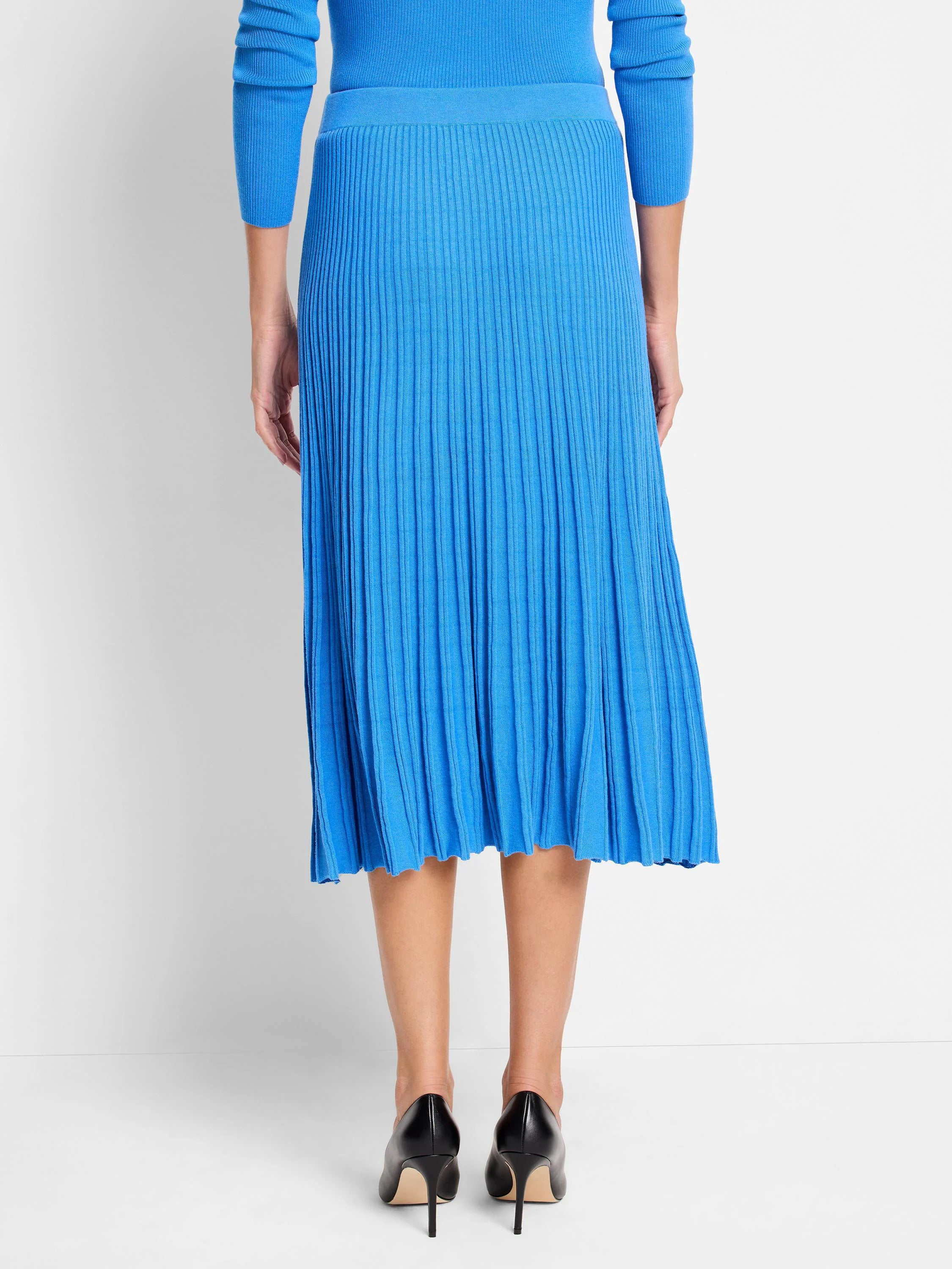 Vibrant blue midi ribbed sweater skirt with distinct vertical ribs and a slight flare.