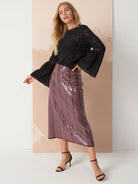 Mauve sequined midi skirt with thin black stripes.
