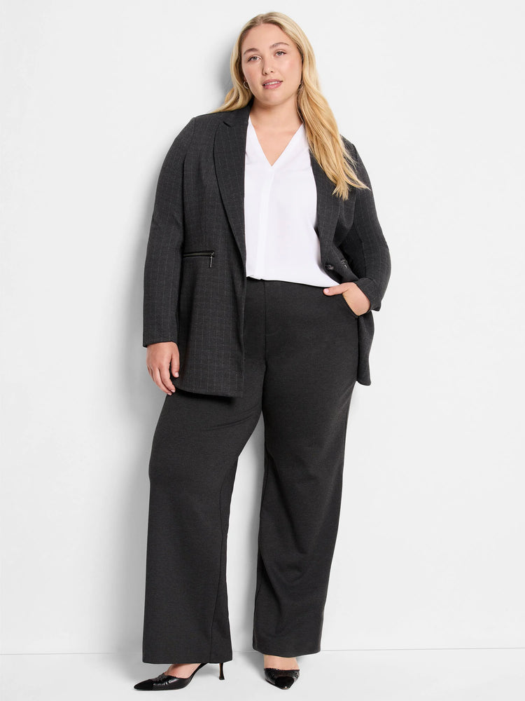 Dark gray wide-leg pants; knit fabric;  model shown wearing them with a blazer and white top.