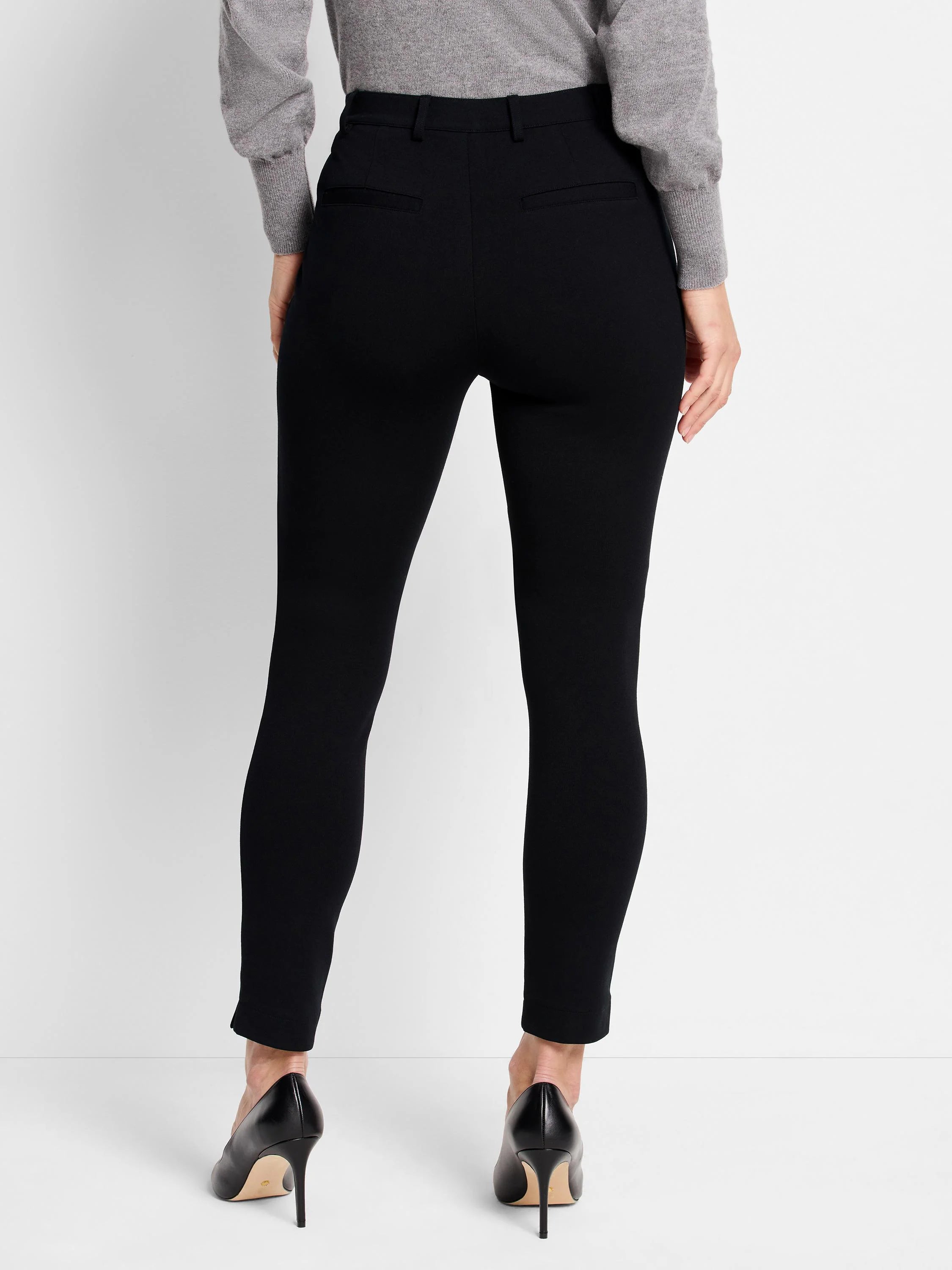 Black knit riding pants, slim-fitting, shown from rear.  Back pockets visible.