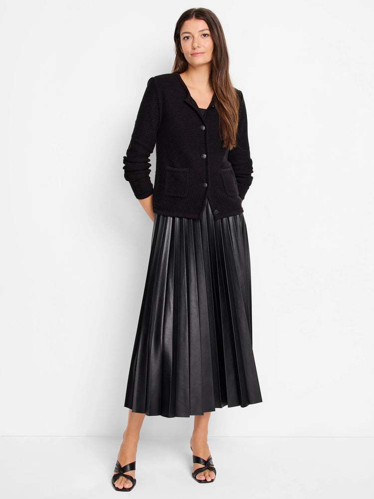 Black pleated faux leather midi skirt.  The skirt is shown on a model.