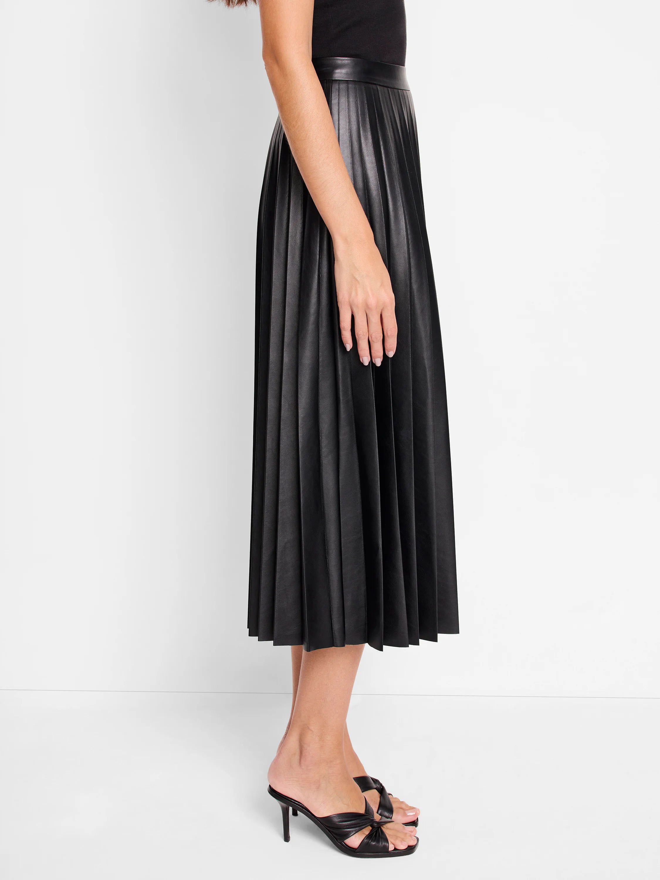 Black faux leather midi skirt with pleats.  A-line silhouette.