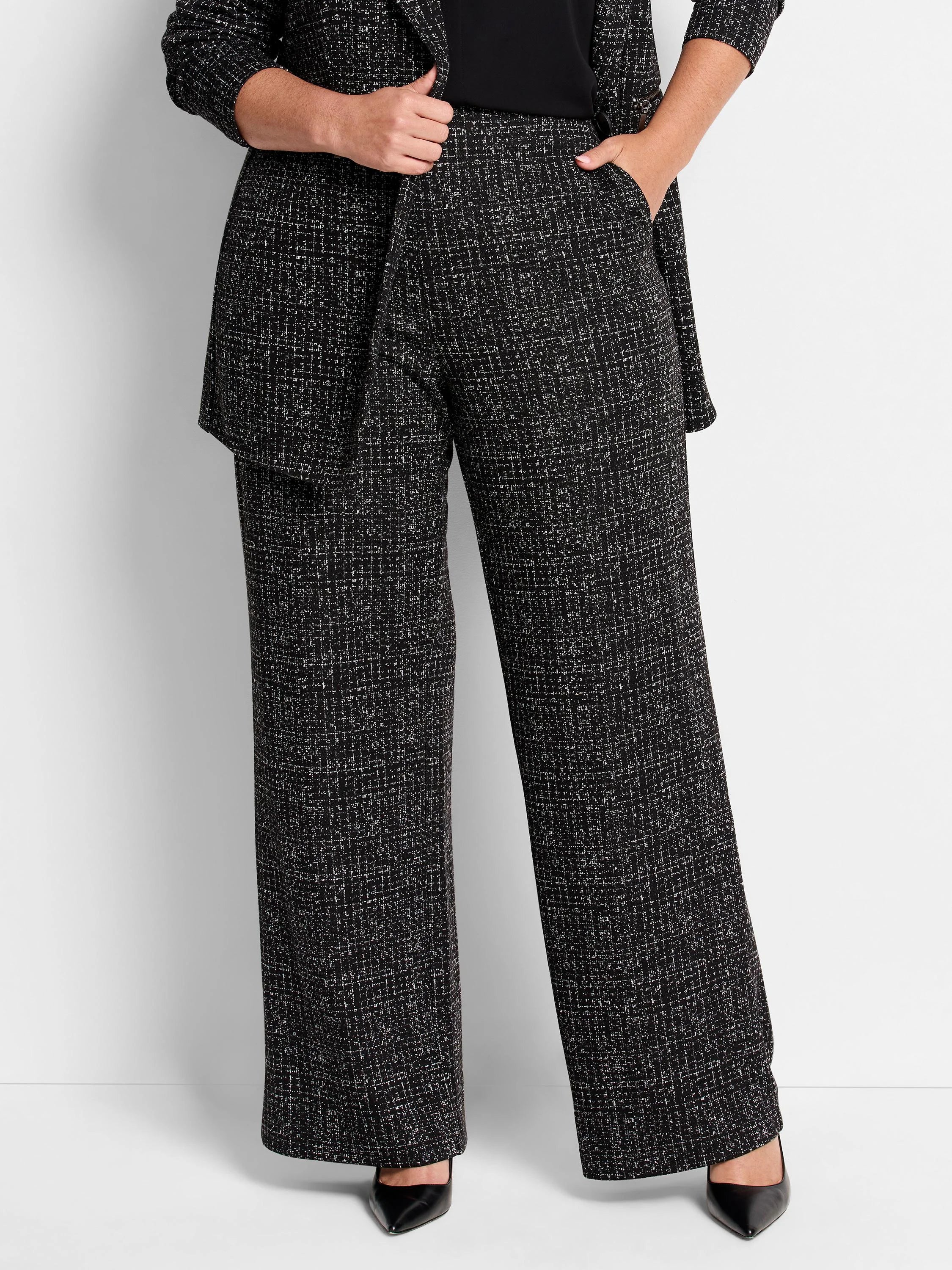 Black wide-leg pants with a small white grid pattern.  Model wears black shoes.