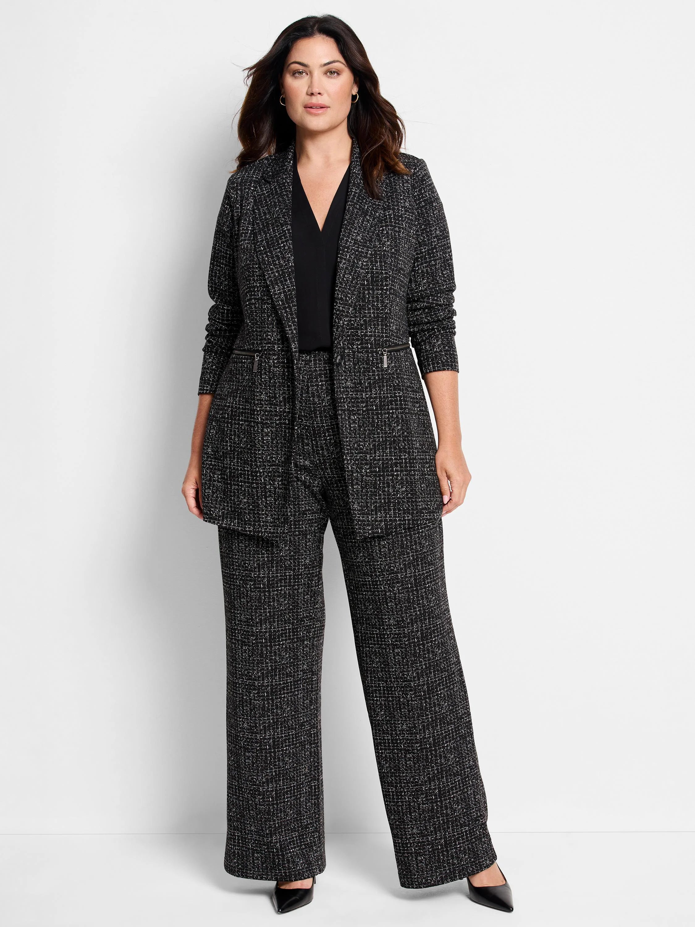 Black wide-leg pants with a white speckled pattern.  The fabric appears knit.