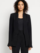 Black open blazer, long sleeves, no collar.  Model wears matching black pants.