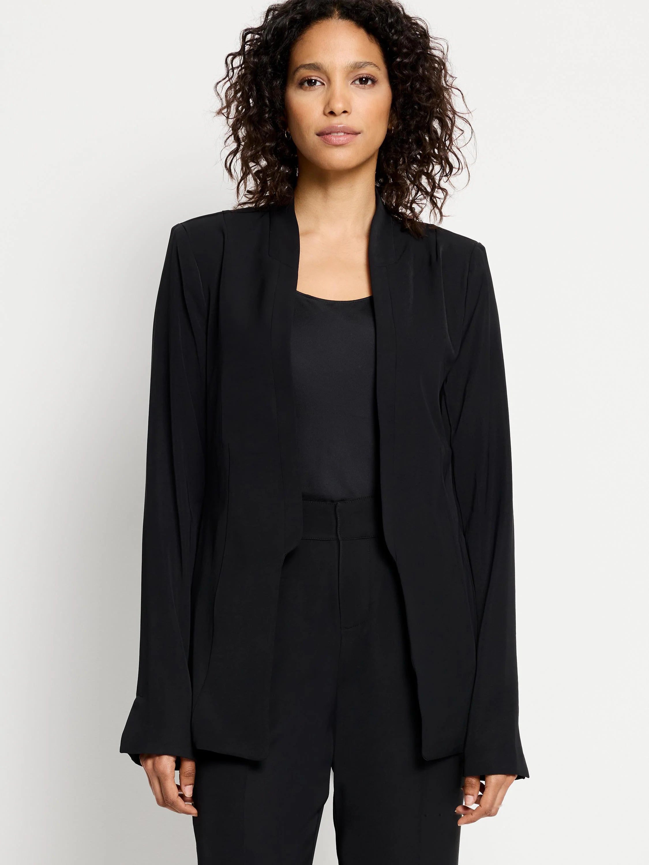 Black open blazer, long sleeves, no collar.  Model wears matching black pants.