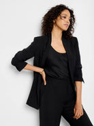 Black blazer, open front, three-quarter sleeves.  Model also wears black top and pants.