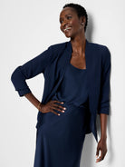 Navy blue open blazer, three-quarter sleeves, worn over matching slip dress.