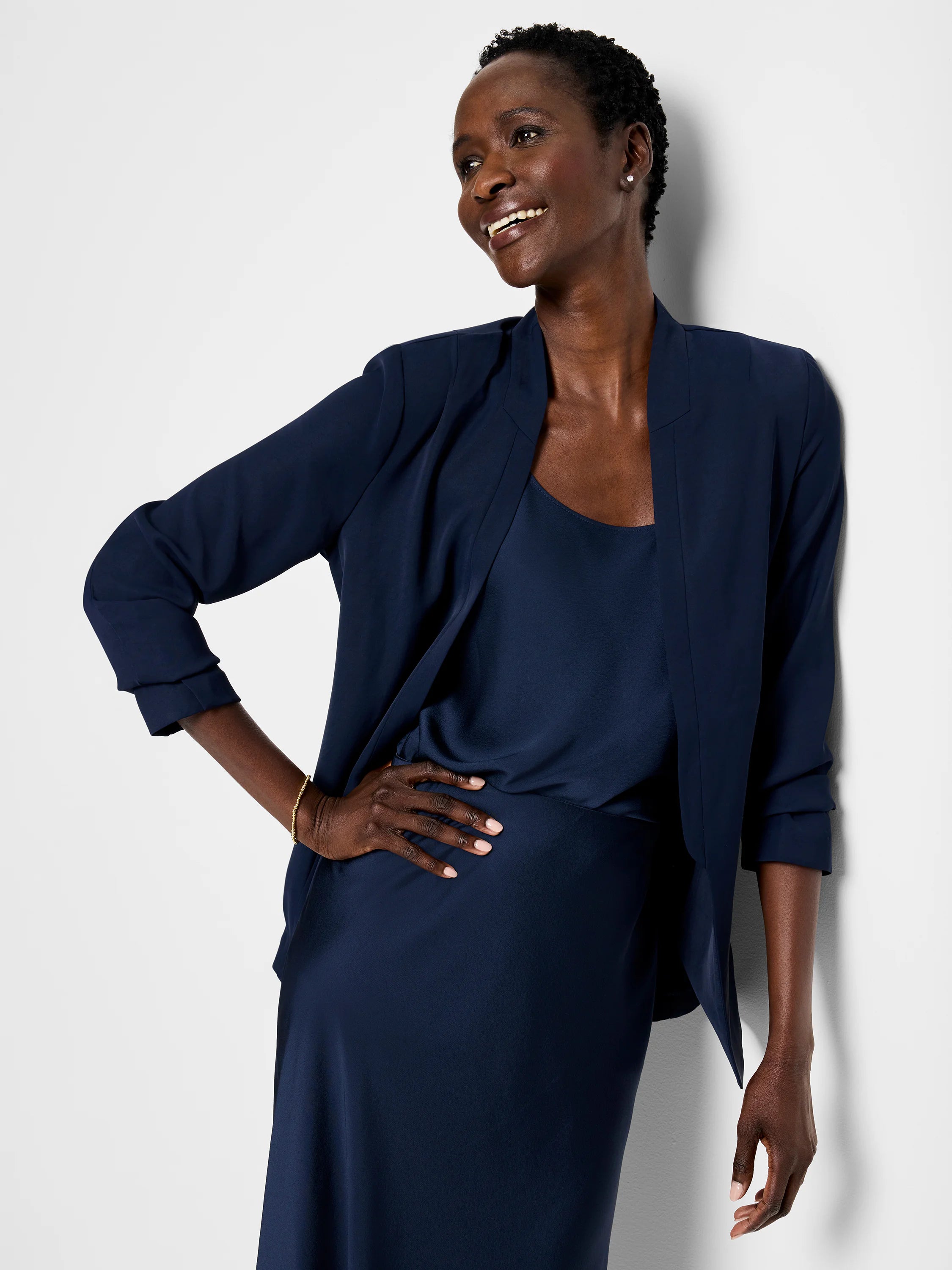 Navy blue open blazer, three-quarter sleeves, worn over matching slip dress.
