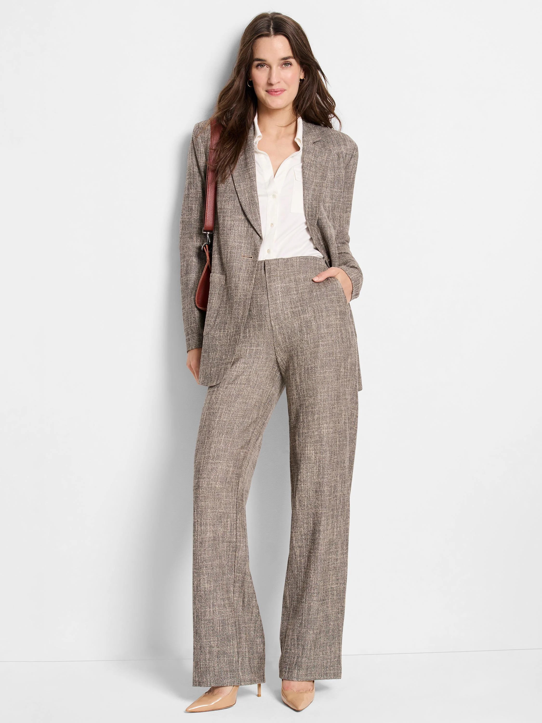 Brown tweed blazer and wide-leg trousers;  subtle beige and brown woven pattern.  Model wears a white shirt.