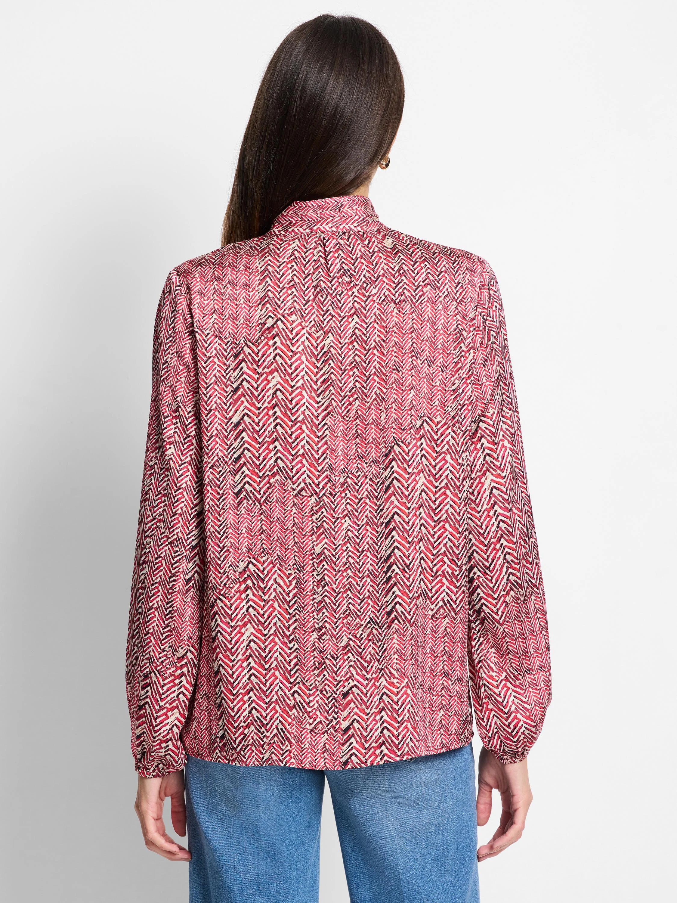 Red and cream herringbone patterned long-sleeve blouse;  back view.