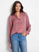 Red, beige, and black herringbone patterned long-sleeve blouse with V-neck.