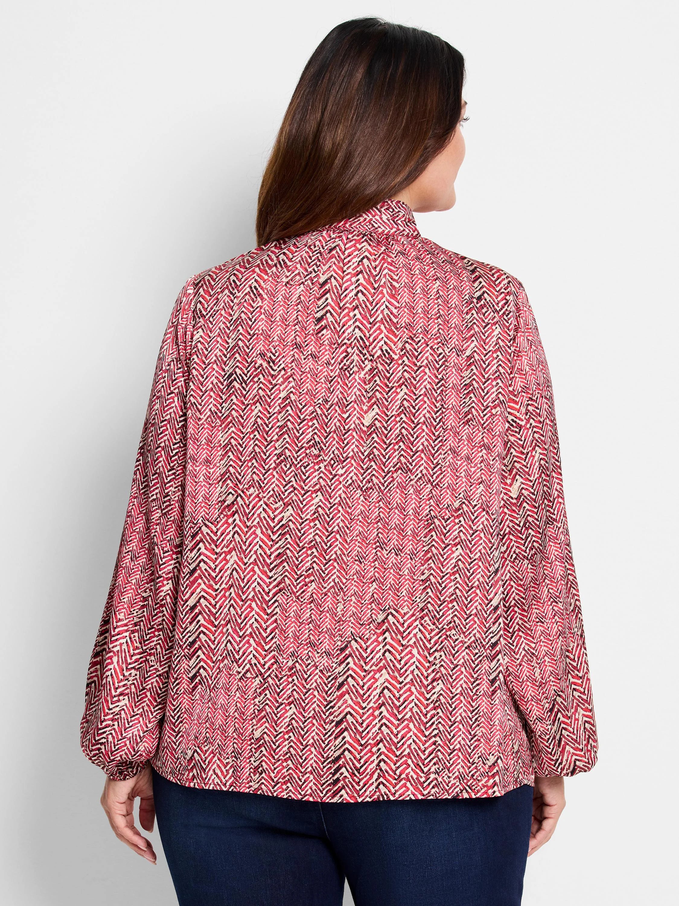 Red and cream herringbone patterned long-sleeve blouse with balloon sleeves and high neck.