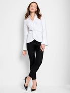 White long-sleeve shirt with a twist front detail.  The sleeves have wide cuffs.