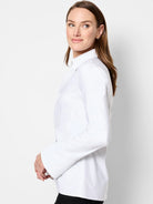 White long-sleeve shirt; collared, twist front, slightly flared cuffs.