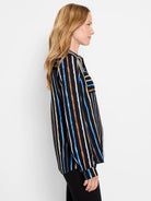 Black shirt with vertical stripes in blue, beige, and brown.  The stripes are painted, giving a slightly uneven texture. ...