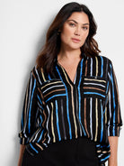 Black shirt with vertical stripes in blue, tan, and gray.  Features long sleeves and chest pockets.