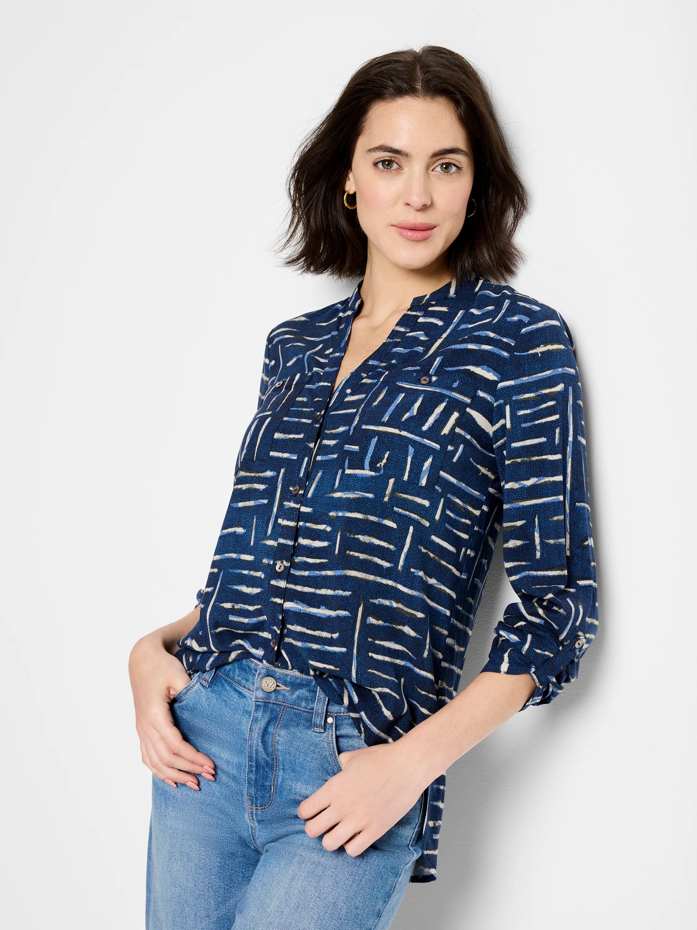 Indigo shirt with an abstract pattern in shades of blue, white, and beige.  Three-quarter sleeves, collared.