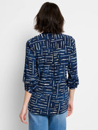 Indigo shirt with off-white and blue abstract linear pattern, long sleeves, and buttoned center back.