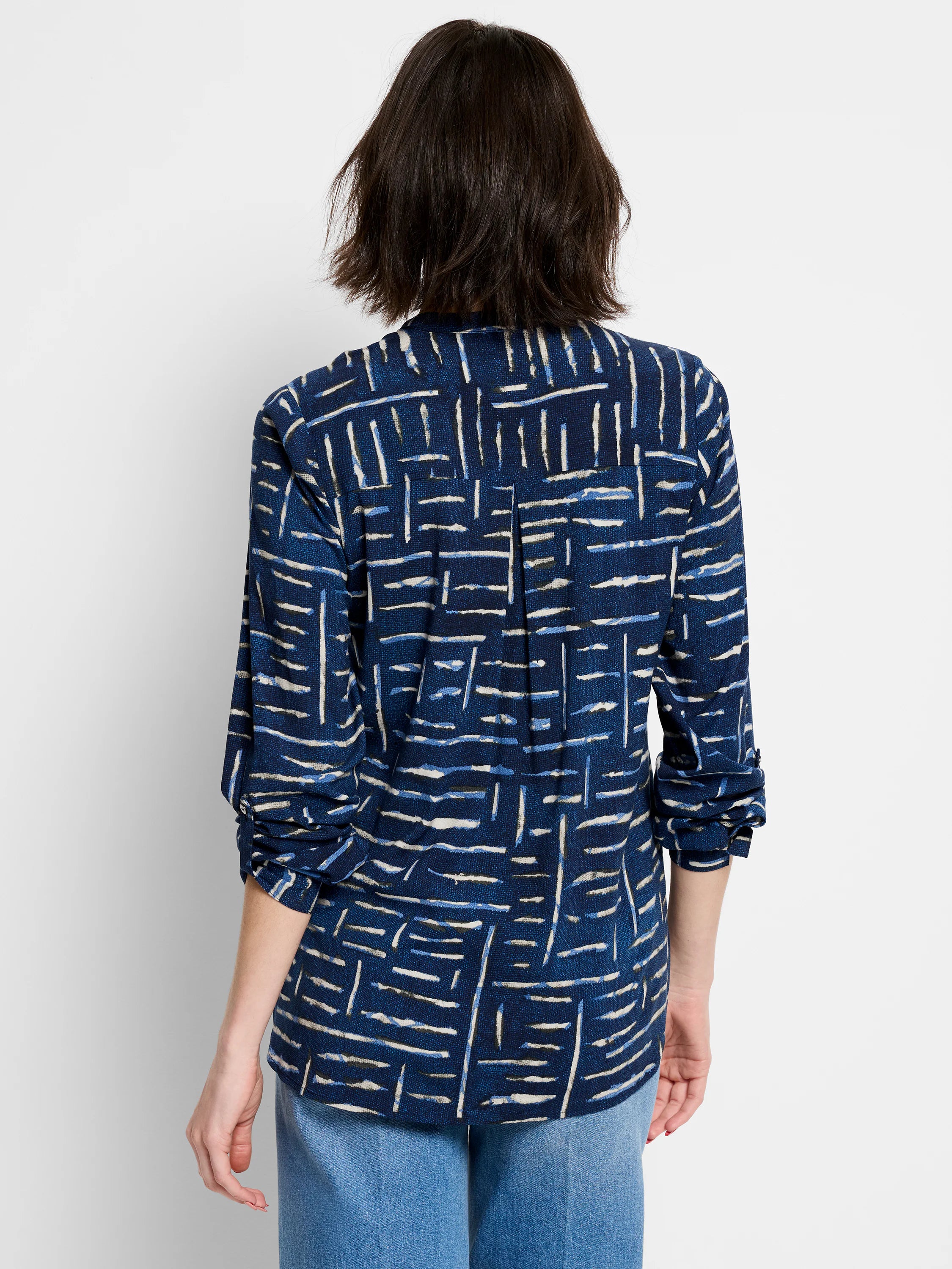 Indigo shirt with off-white and blue abstract linear pattern, long sleeves, and buttoned center back.