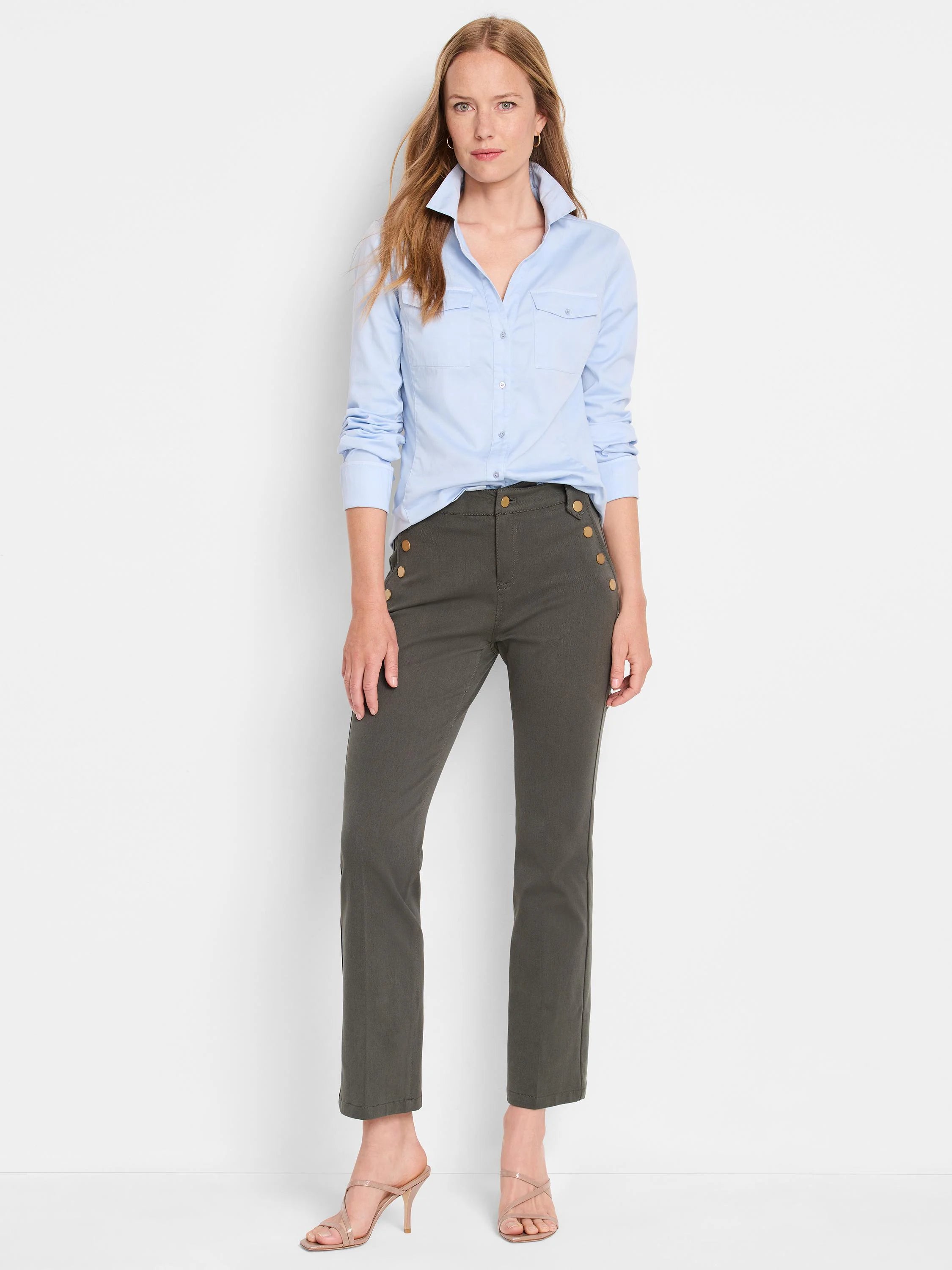 Light blue long-sleeve button-down shirt with pockets, worn with olive green pants featuring gold buttons.