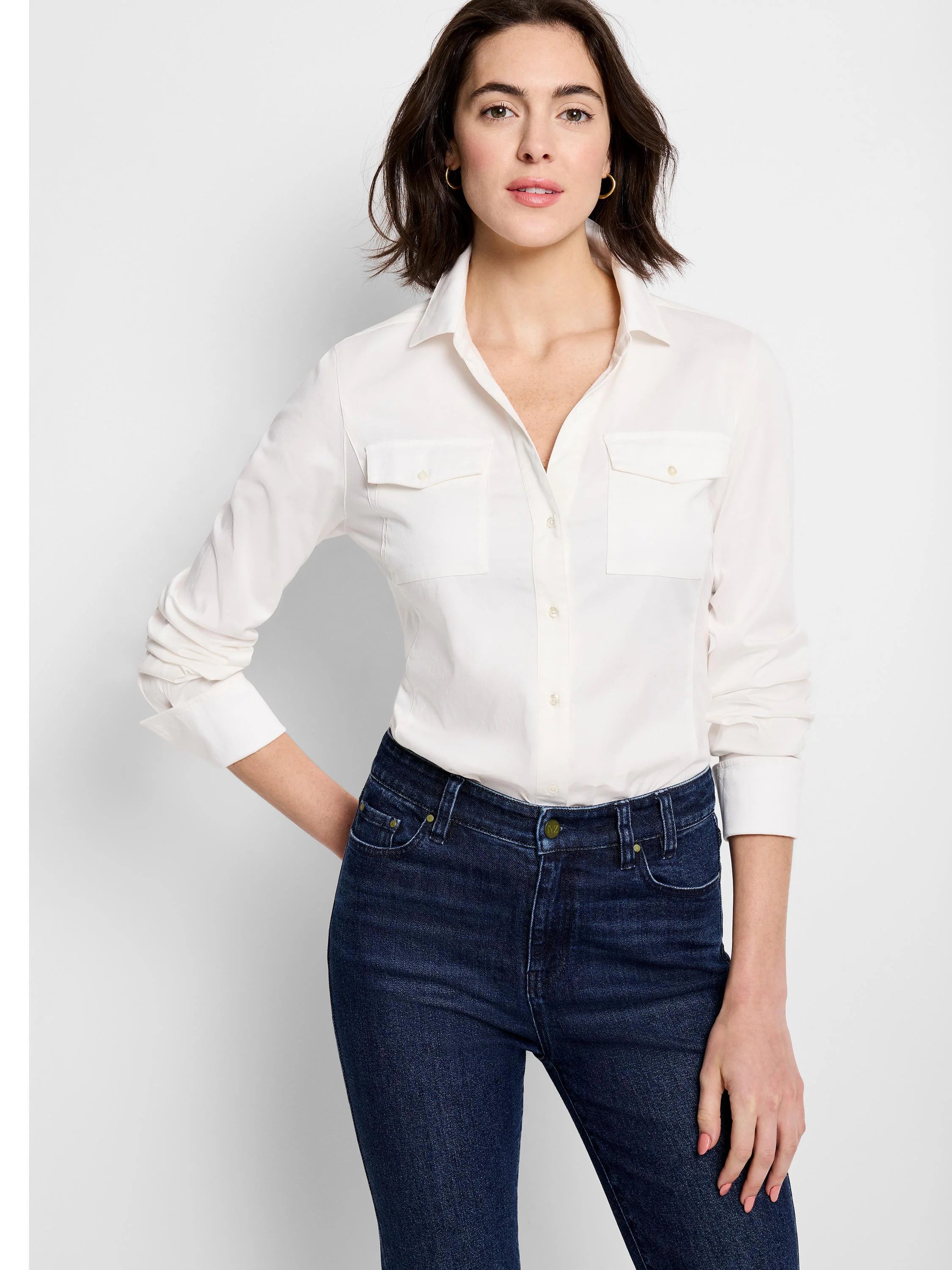 Off-white, long-sleeve button-down shirt; two chest pockets; shown with dark wash jeans.
