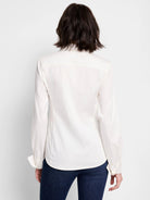 Off-white long-sleeve collared shirt, button cuffs, shown from the back.