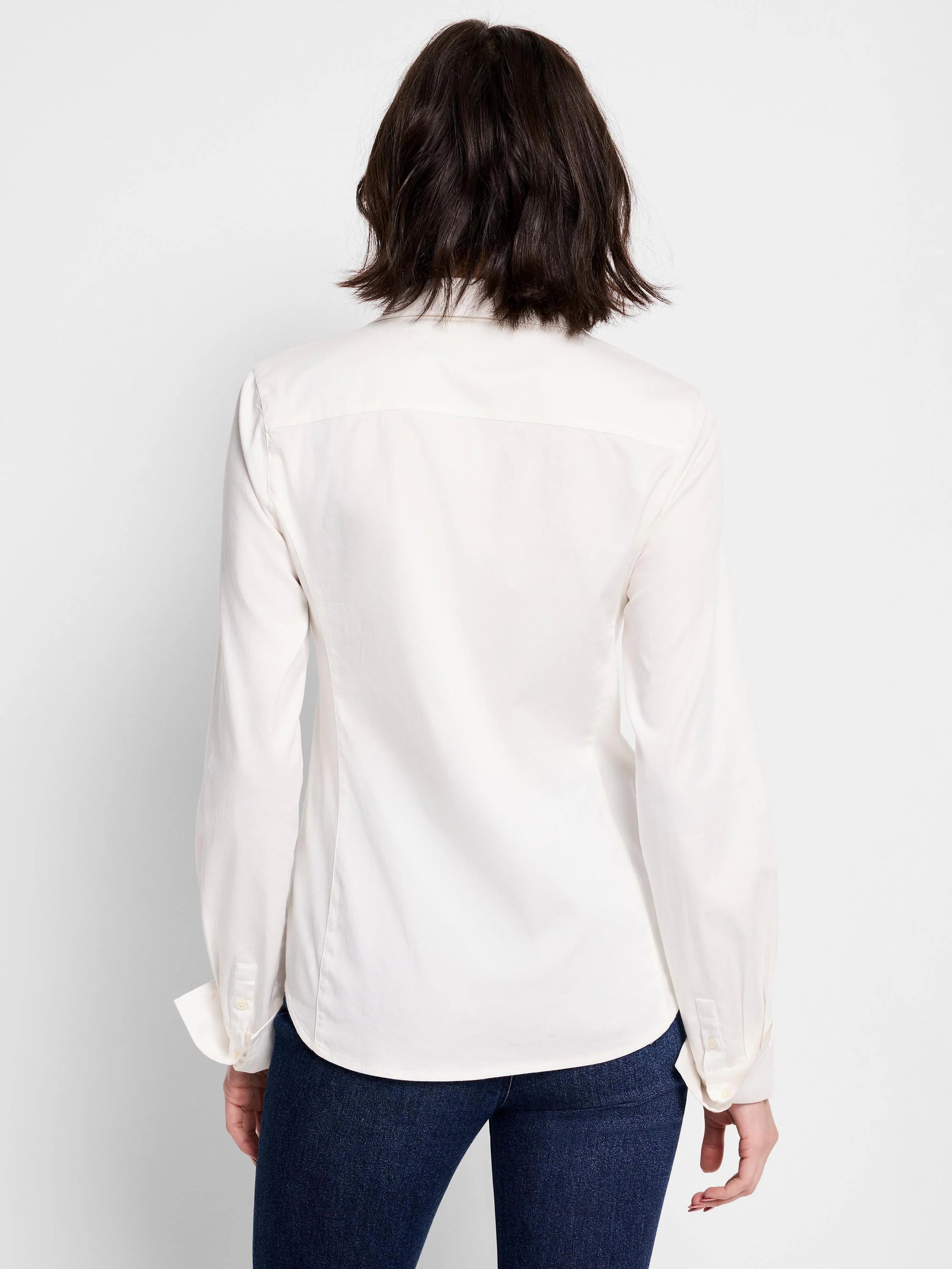 Off-white long-sleeve collared shirt, button cuffs, shown from the back.