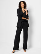 Black crepe cami and pants; model wears matching black blazer.