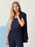 Navy blue sleeveless crepe cami.  Model wears matching navy trousers.  Simple, scoop neckline.